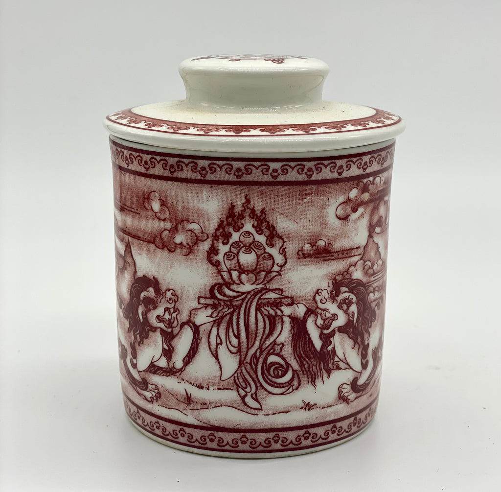 Potala Gate dark red cup with 2 snow lions facing the 3 jewels, in a mountainous and cloudy background.  The lid has a dharma wheel.